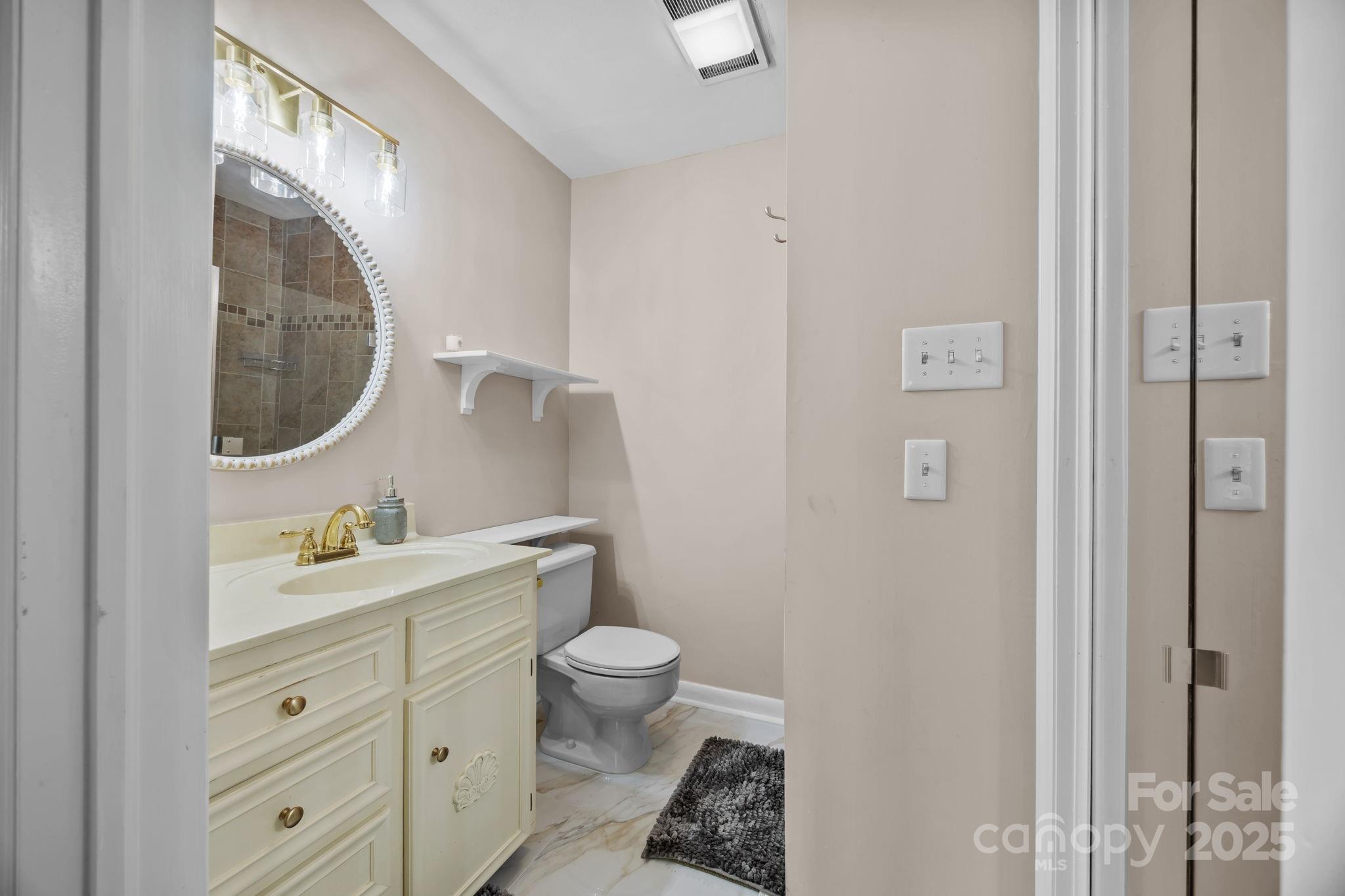 241 Stonewall Road Salisbury, NC 28144 - Photo 30 of 48 a bathroom with a toilet sink and mirror