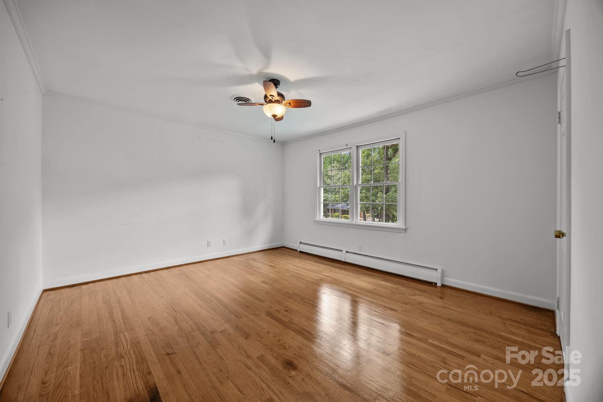 241 Stonewall Road Salisbury, NC 28144 - Photo 32 of 48 an empty room with windows and chandelier fan