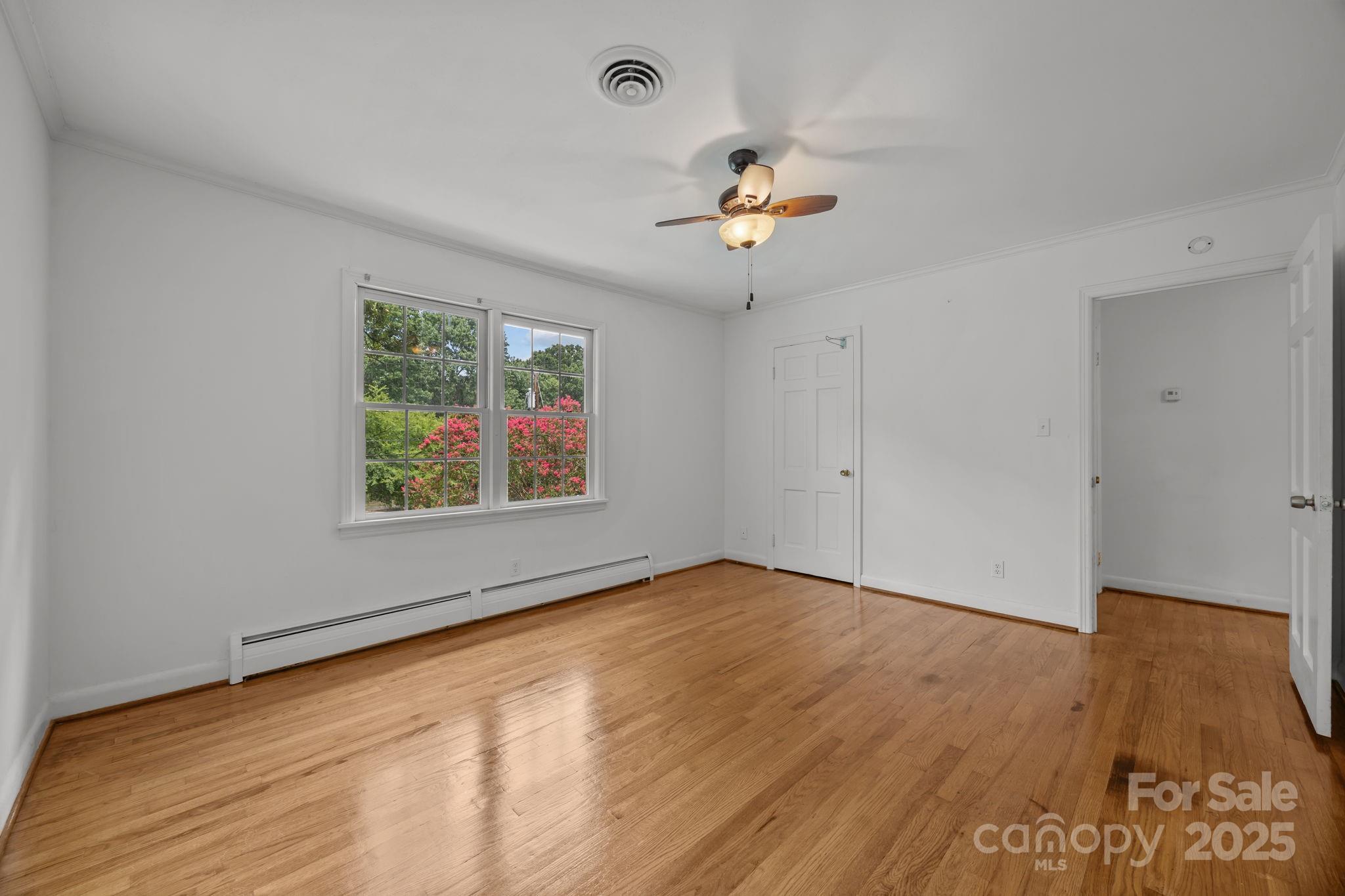 241 Stonewall Road Salisbury, NC 28144 - Photo 33 of 48 an empty room with wooden floor and ceiling fan
