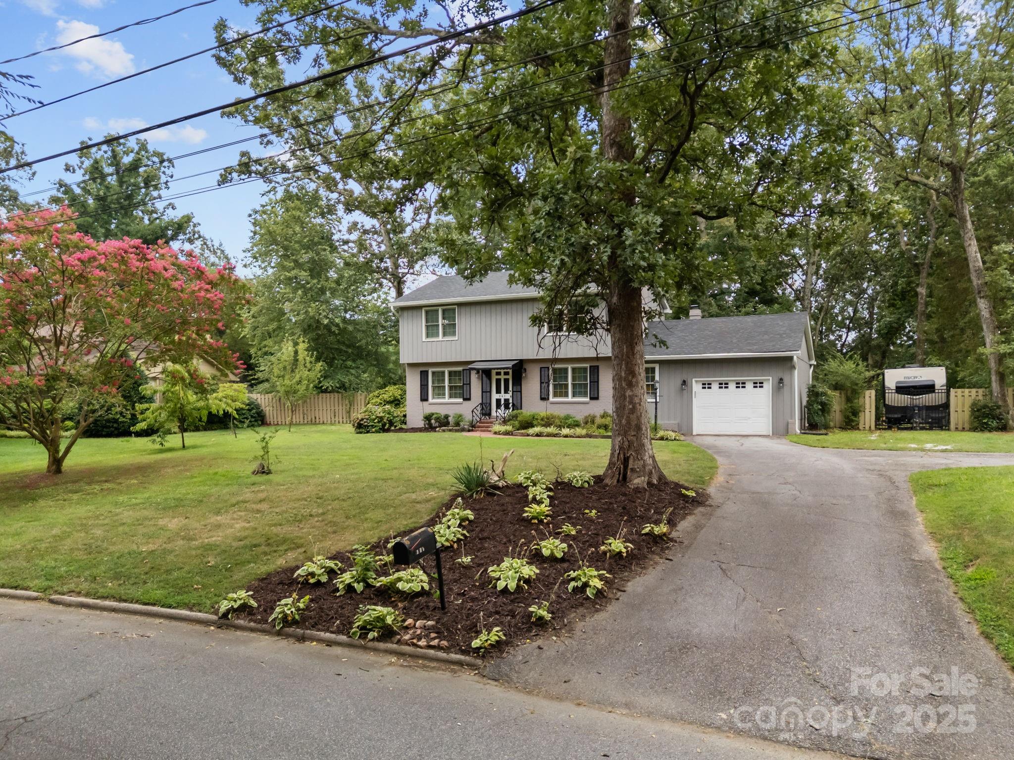 241 Stonewall Road Salisbury, NC 28144 - Photo 8 of 48 a front view of a house with a garden and trees