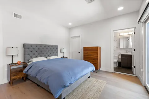 a bedroom with a bed and a television