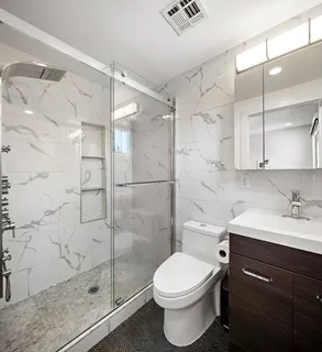 a bathroom with a sink toilet and shower