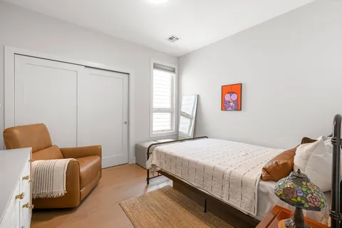 a bedroom with bed and a couch