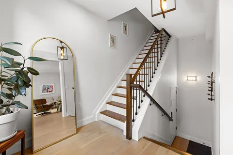 a view of staircase with white walls and a window