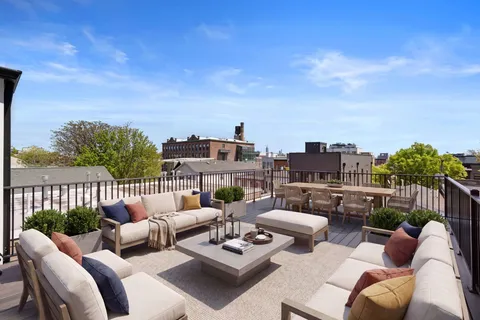 a view of a balcony with furniture