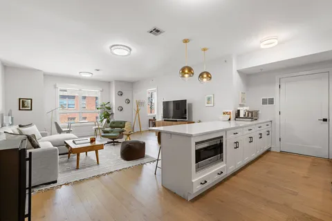 a kitchen with kitchen island a white counter top space and appliances