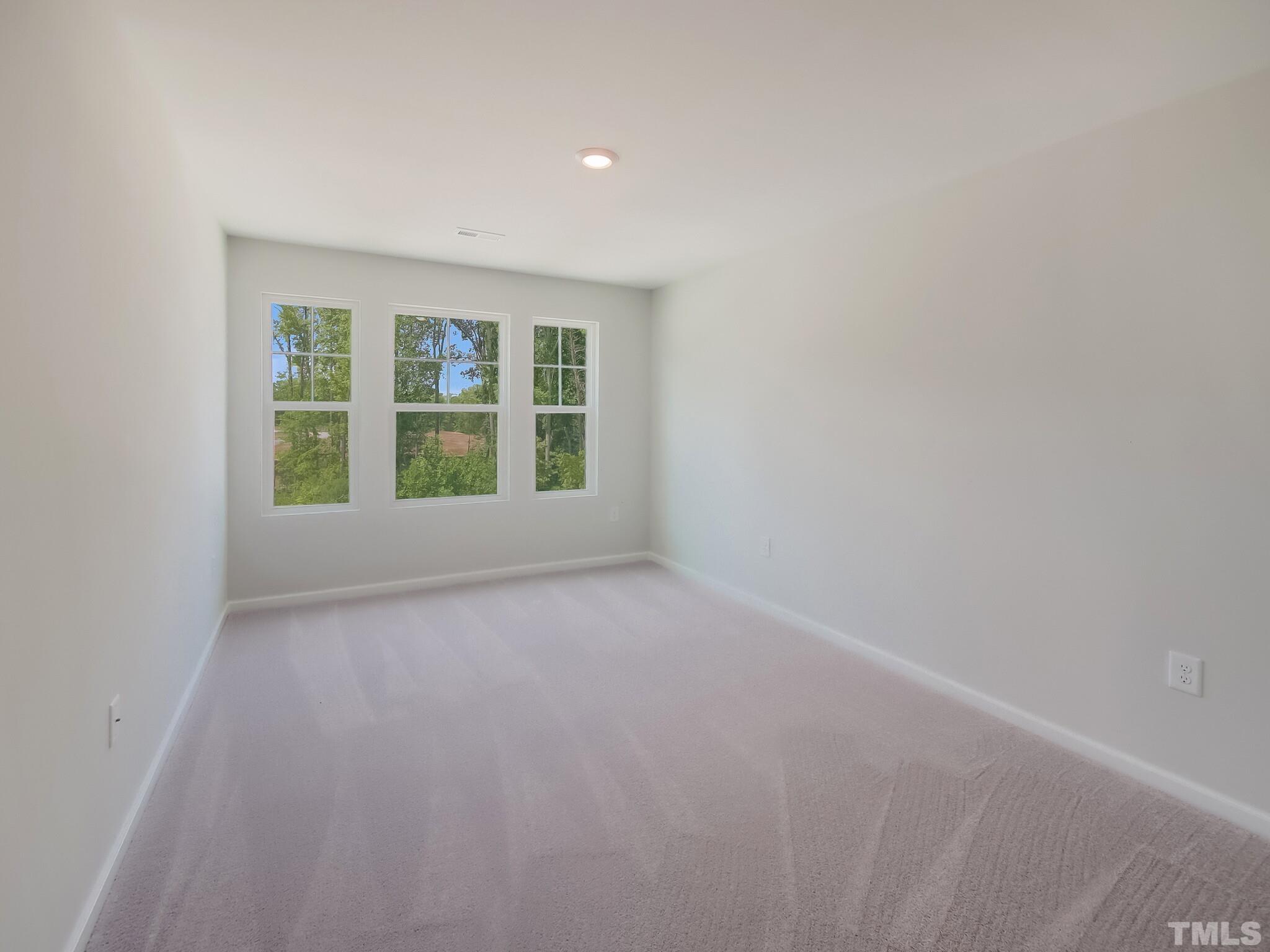 1623 Emory Ridge Way Wake Forest, NC 27587 - Photo 22 of 25 a view of an empty room with a window