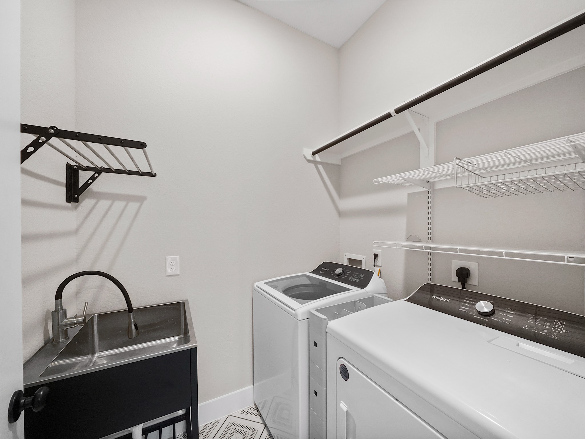 30214 Crossfield Road Fulshear, TX 77441 - Photo 24 of 42 The utility room includes washer and dryer connections, a utility sink, and practical storage space for day-to-day organization.