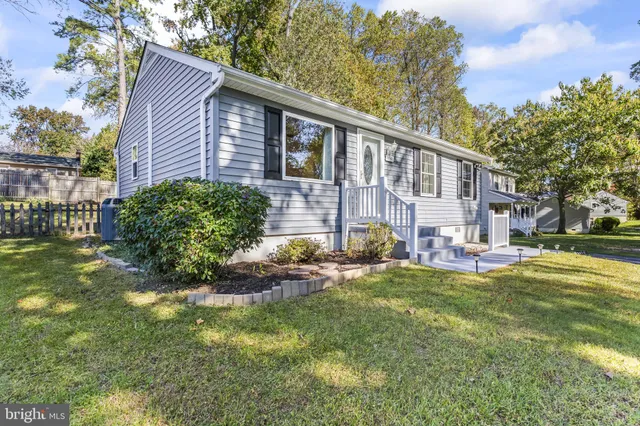 a front view of a house with a yard table and chairs
