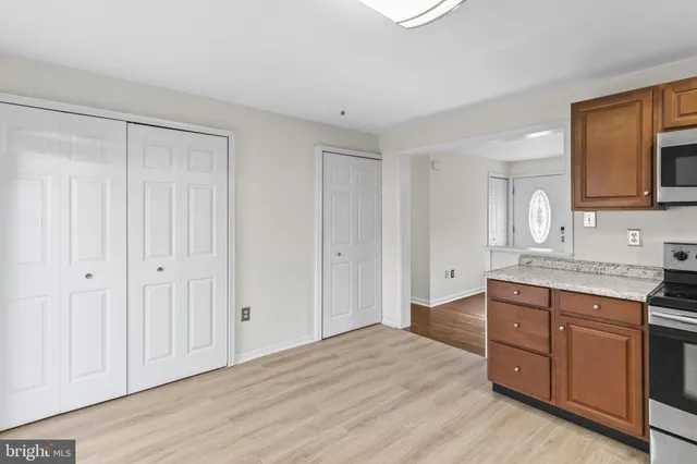 a spacious bathroom with a granite countertop sink and a mirror
