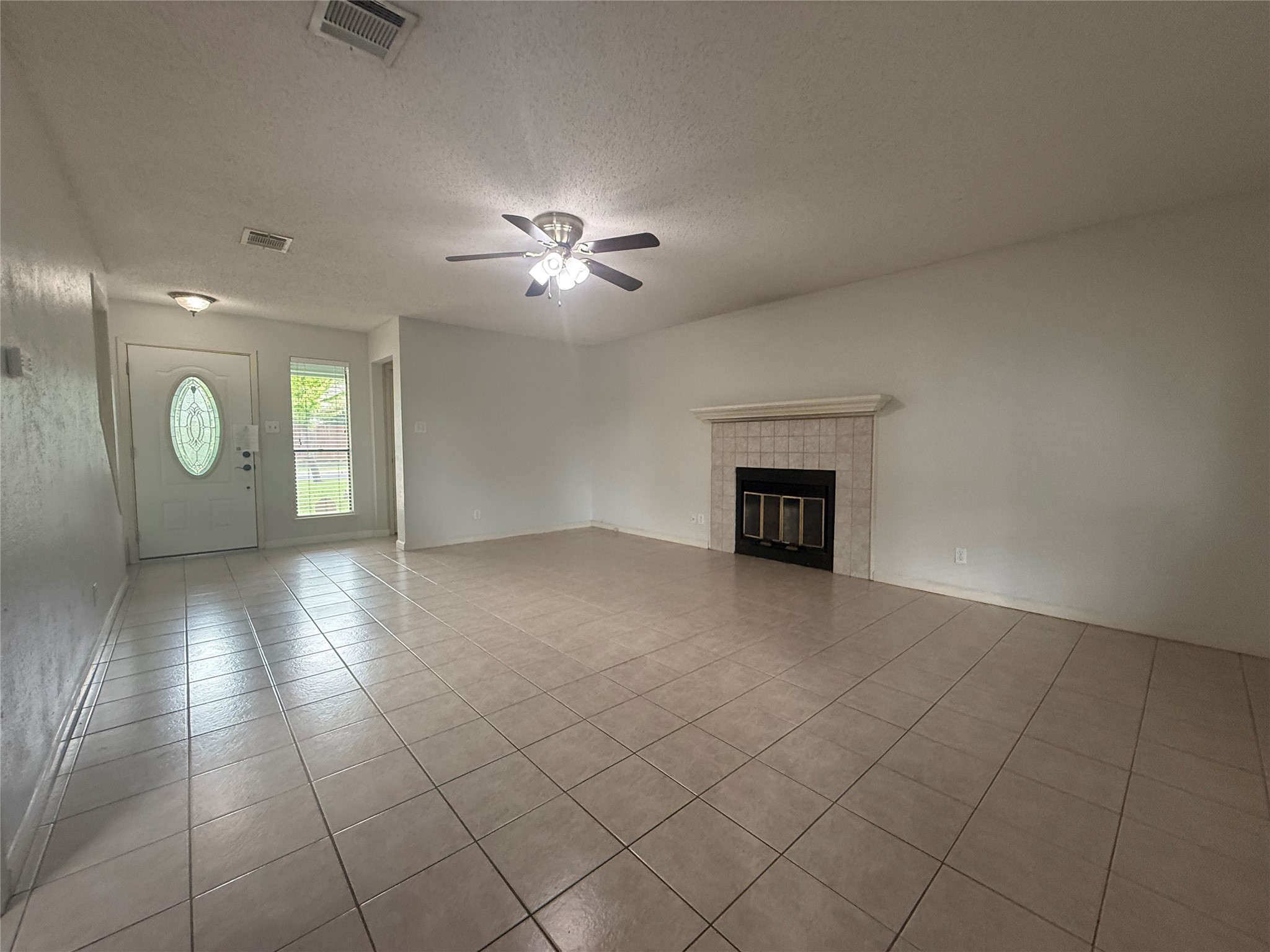 7900 Turquoise Trail Austin, TX 78749 - Photo 4 of 21 A spacious living area with ceramic tile flooring and a focal fireplace.