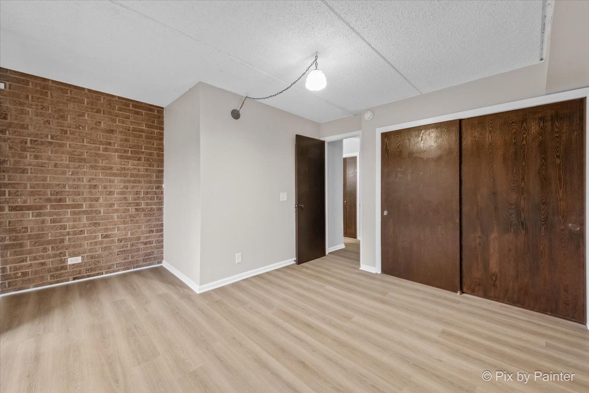 712 Kenneth Circle Elgin, IL 60120 - Photo 13 of 27 a view of an empty room with wooden floor and a window