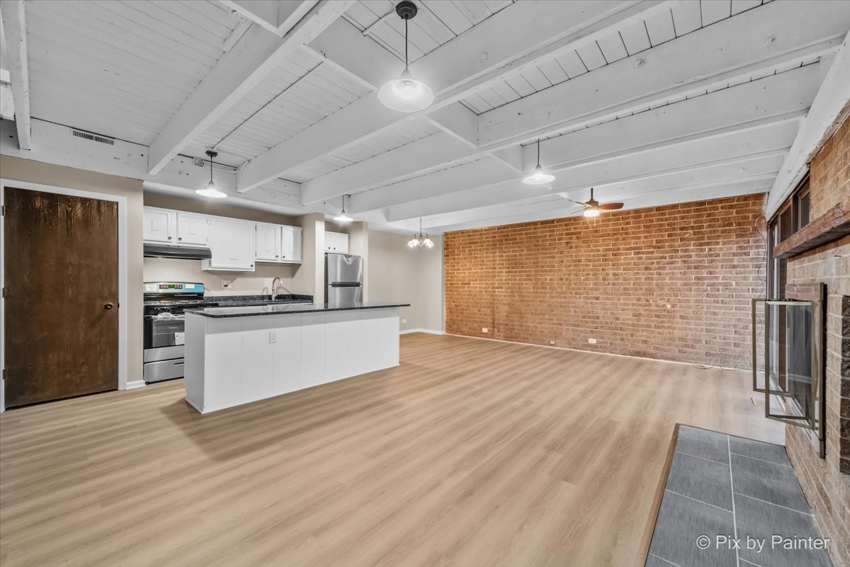 712 Kenneth Circle Elgin, IL 60120 - Photo 2 of 27 a large kitchen with stainless steel appliances kitchen island granite countertop a refrigerator and a stove