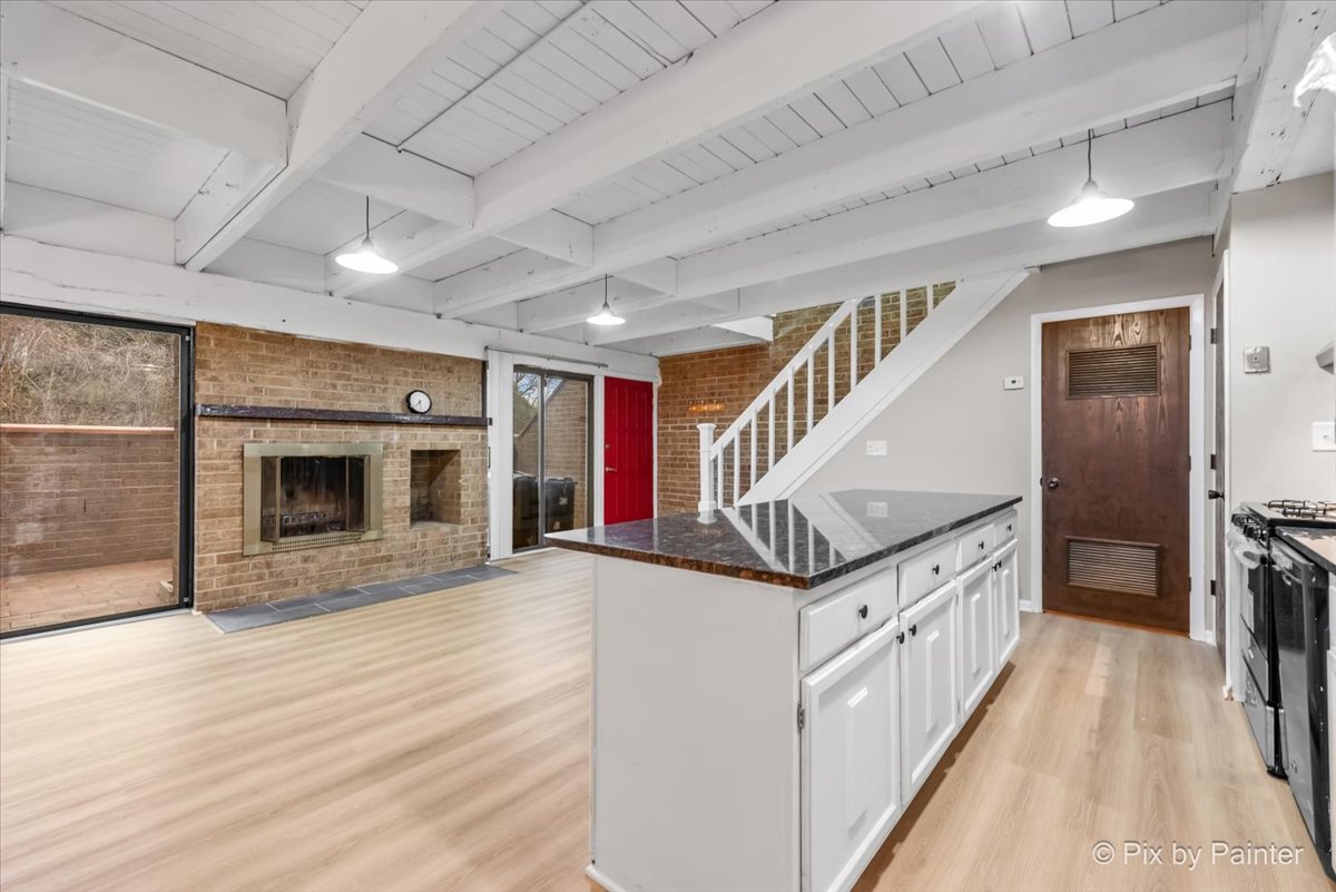 712 Kenneth Circle Elgin, IL 60120 - Photo 4 of 27 a view of a hallway with wooden floor and staircase