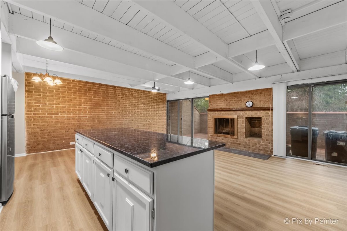 712 Kenneth Circle Elgin, IL 60120 - Photo 7 of 27 a kitchen with stainless steel appliances granite countertop a sink stove and cabinets