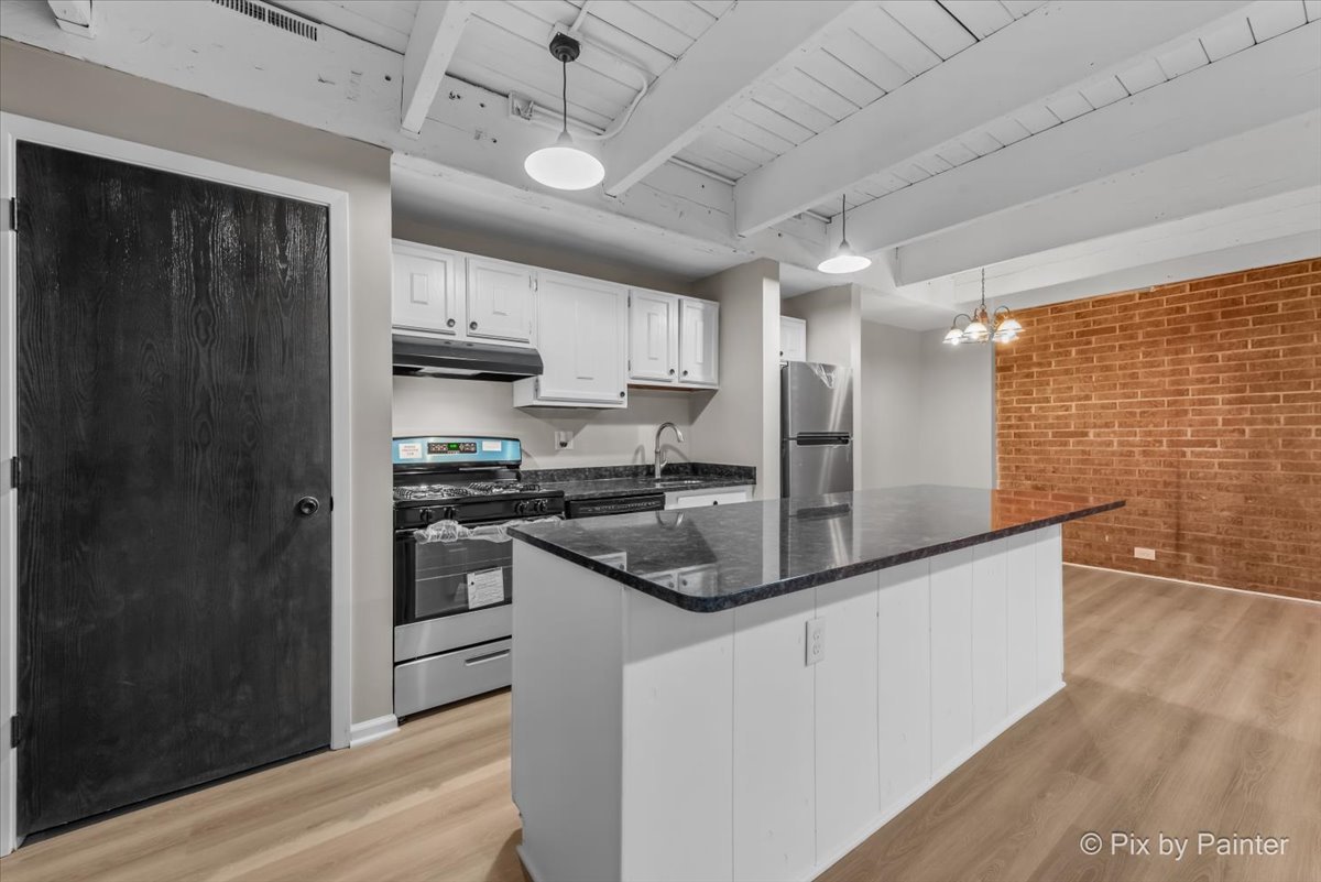 712 Kenneth Circle Elgin, IL 60120 - Photo 8 of 27 a kitchen with stainless steel appliances granite countertop a sink a stove and a refrigerator