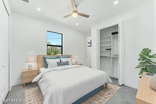 a bedroom with a bed and a potted plant