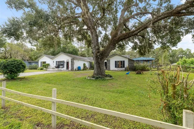 a front view of house with yard and green space