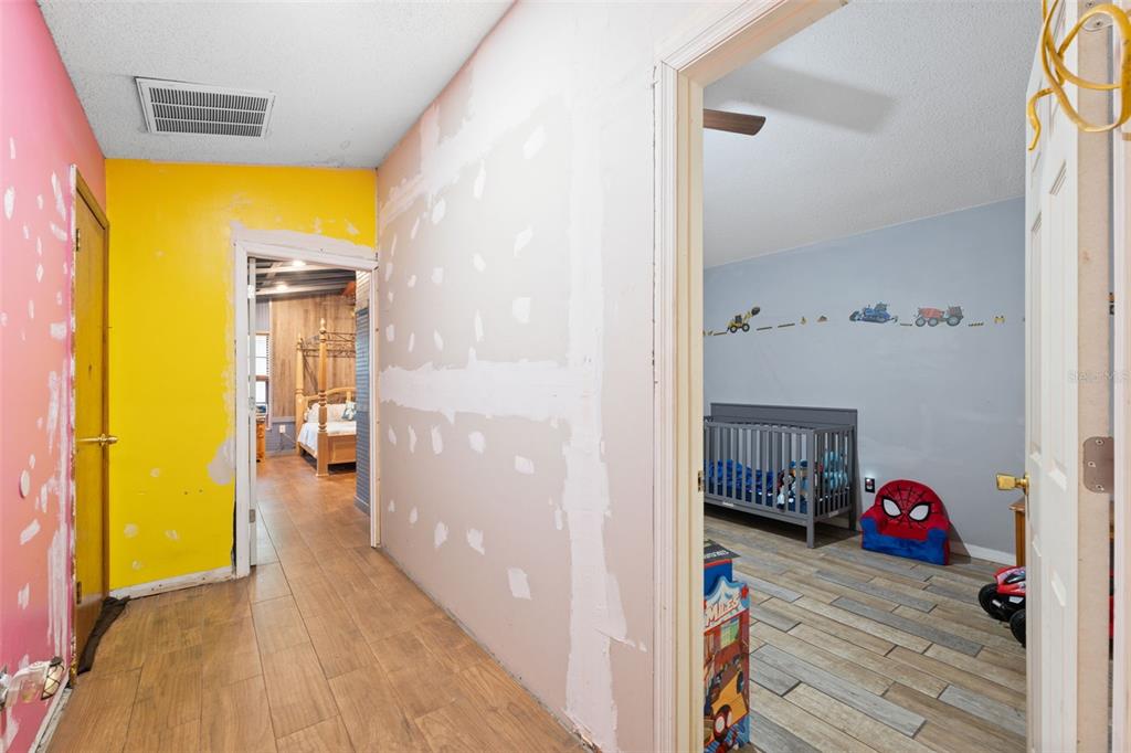 18160 Spangler Avenue Brooksville, FL 34604 - Photo 13 of 37 a view of a bedroom from a hallway