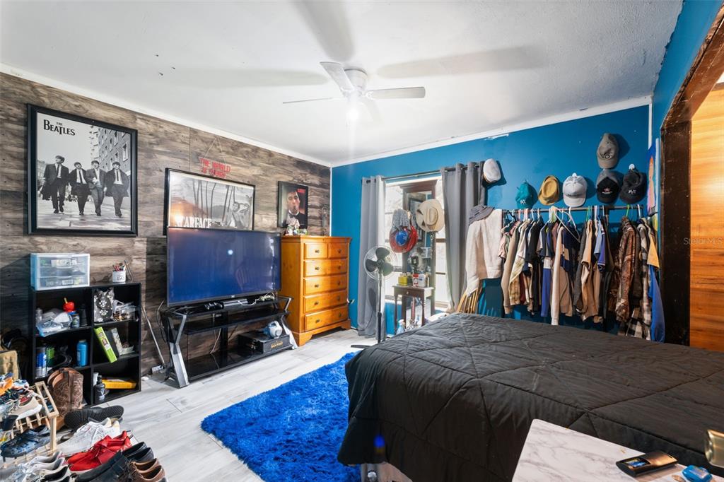 18160 Spangler Avenue Brooksville, FL 34604 - Photo 15 of 37 a bed room with a bed a window and a flat screen tv