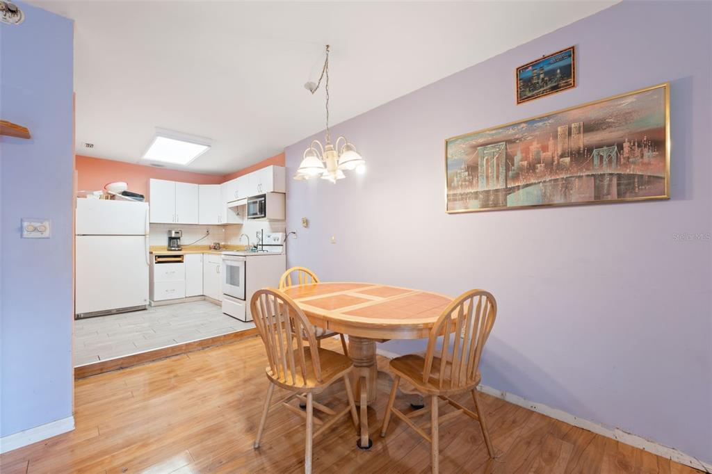 18160 Spangler Avenue Brooksville, FL 34604 - Photo 21 of 37 a view of a dining room with furniture and wooden floor