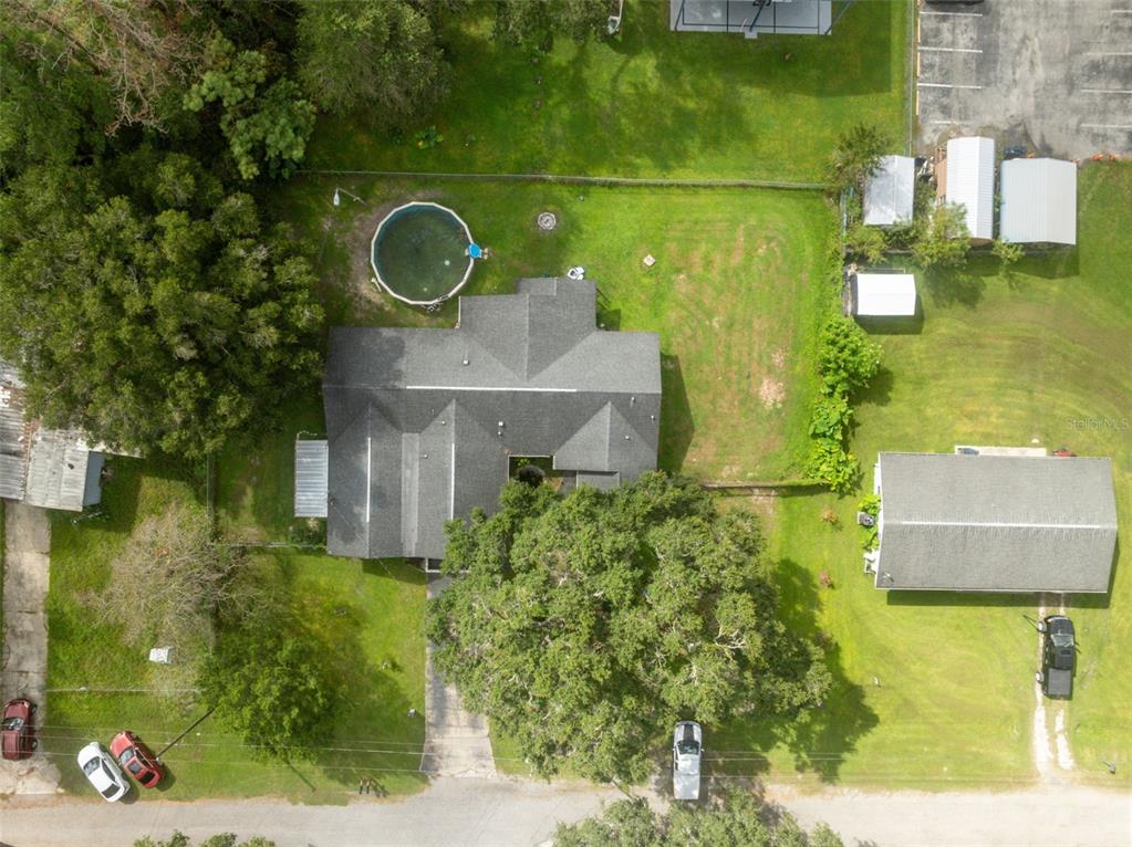 18160 Spangler Avenue Brooksville, FL 34604 - Photo 3 of 37 an aerial view of a house with a yard basket ball court and outdoor seating