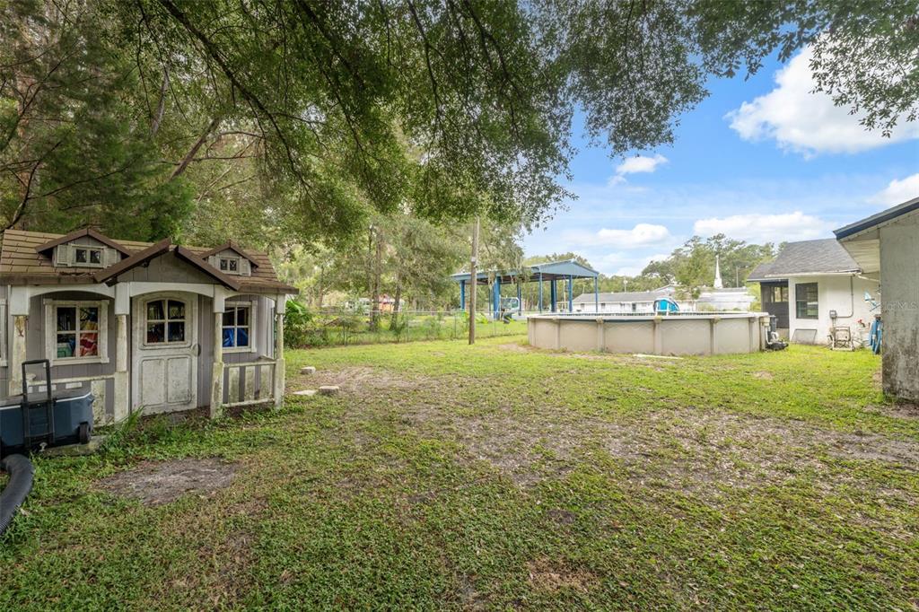 18160 Spangler Avenue Brooksville, FL 34604 - Photo 32 of 37 a front view of a house with yard and green space