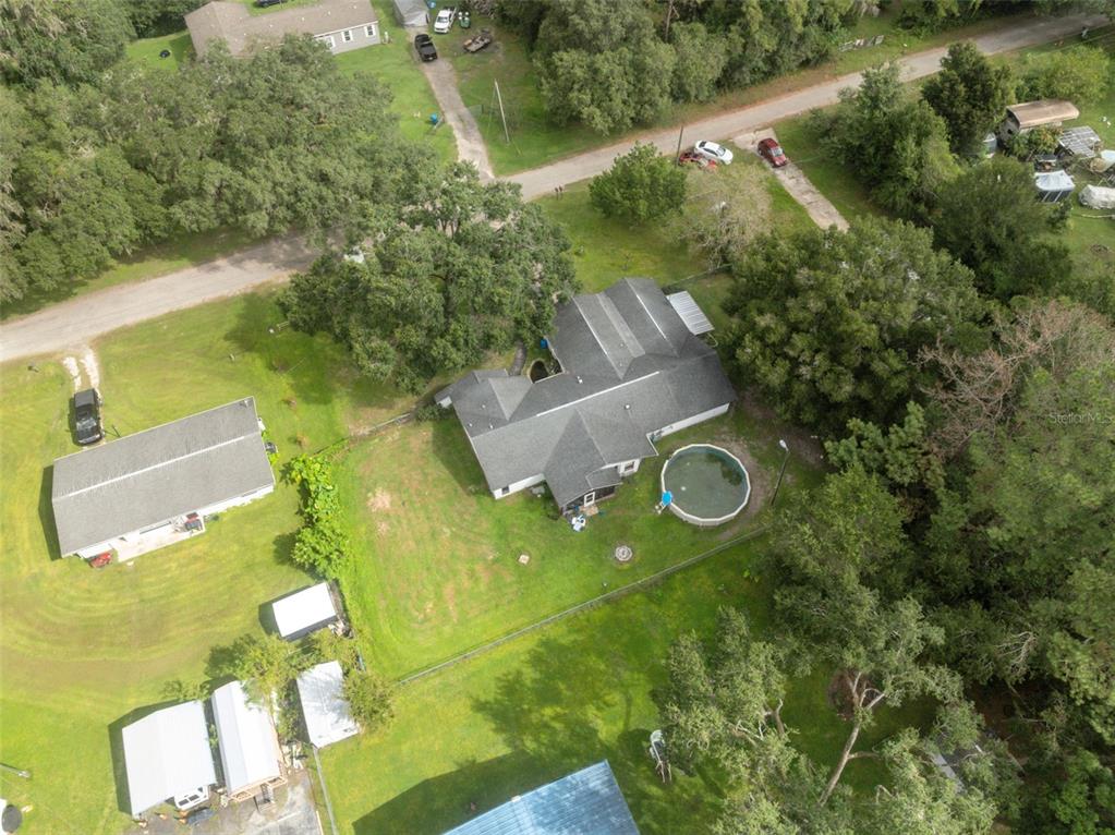18160 Spangler Avenue Brooksville, FL 34604 - Photo 34 of 37 an aerial view of a house with pool yard seating and yard