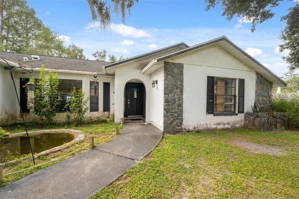 18160 Spangler Avenue Brooksville, FL 34604 - Photo 4 of 37 a view of a house with a swimming pool and porch with furniture