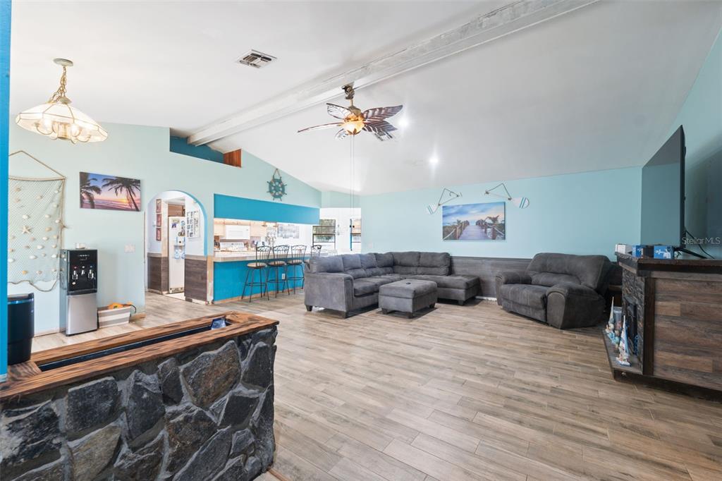 18160 Spangler Avenue Brooksville, FL 34604 - Photo 5 of 37 a living room with fireplace furniture and a flat screen tv