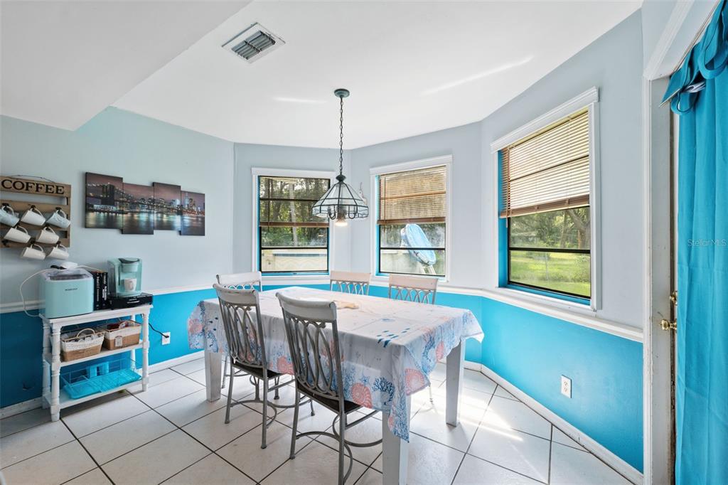 18160 Spangler Avenue Brooksville, FL 34604 - Photo 8 of 37 a view of a dining room with furniture window and outside view