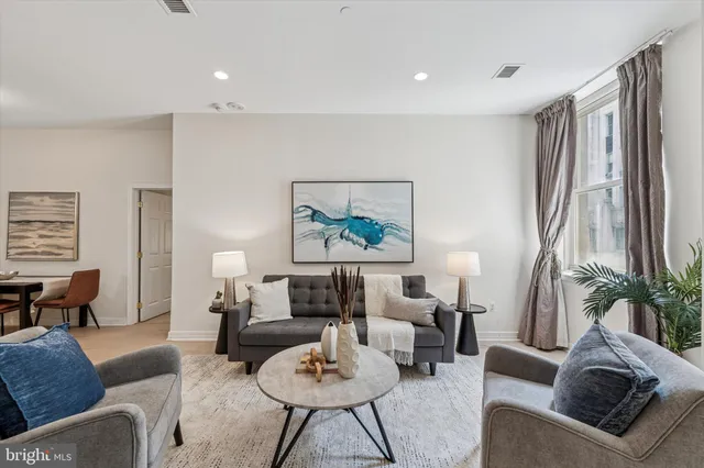 a living room with furniture and a large window