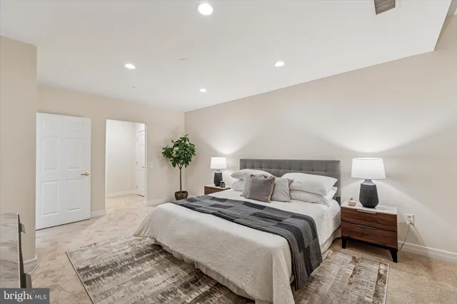 a bedroom with a bed and a potted plant