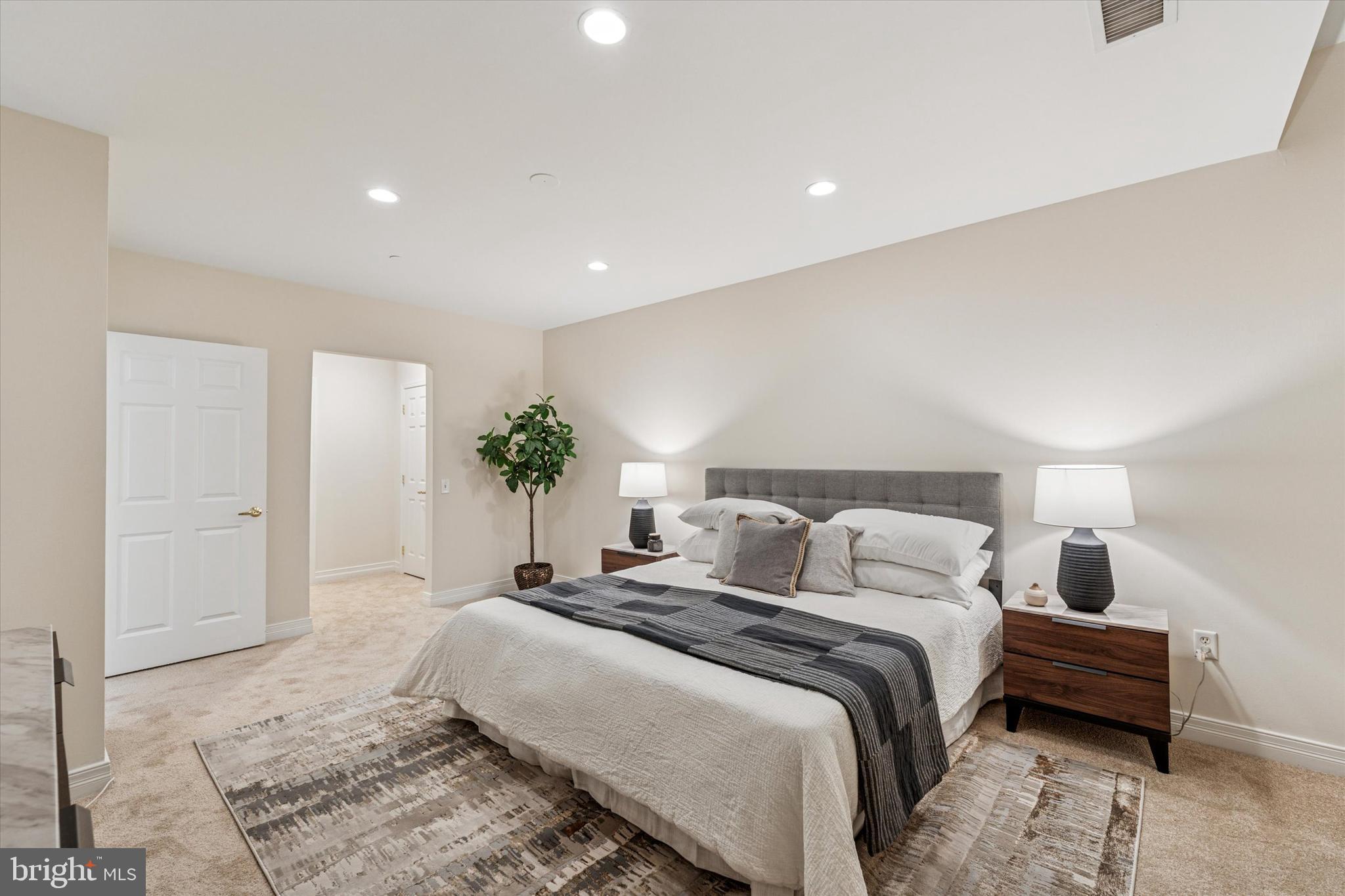 1600 Arch Street, Unit 1706 Philadelphia, PA 19103 - Photo 15 of 34 a bedroom with a bed and a potted plant