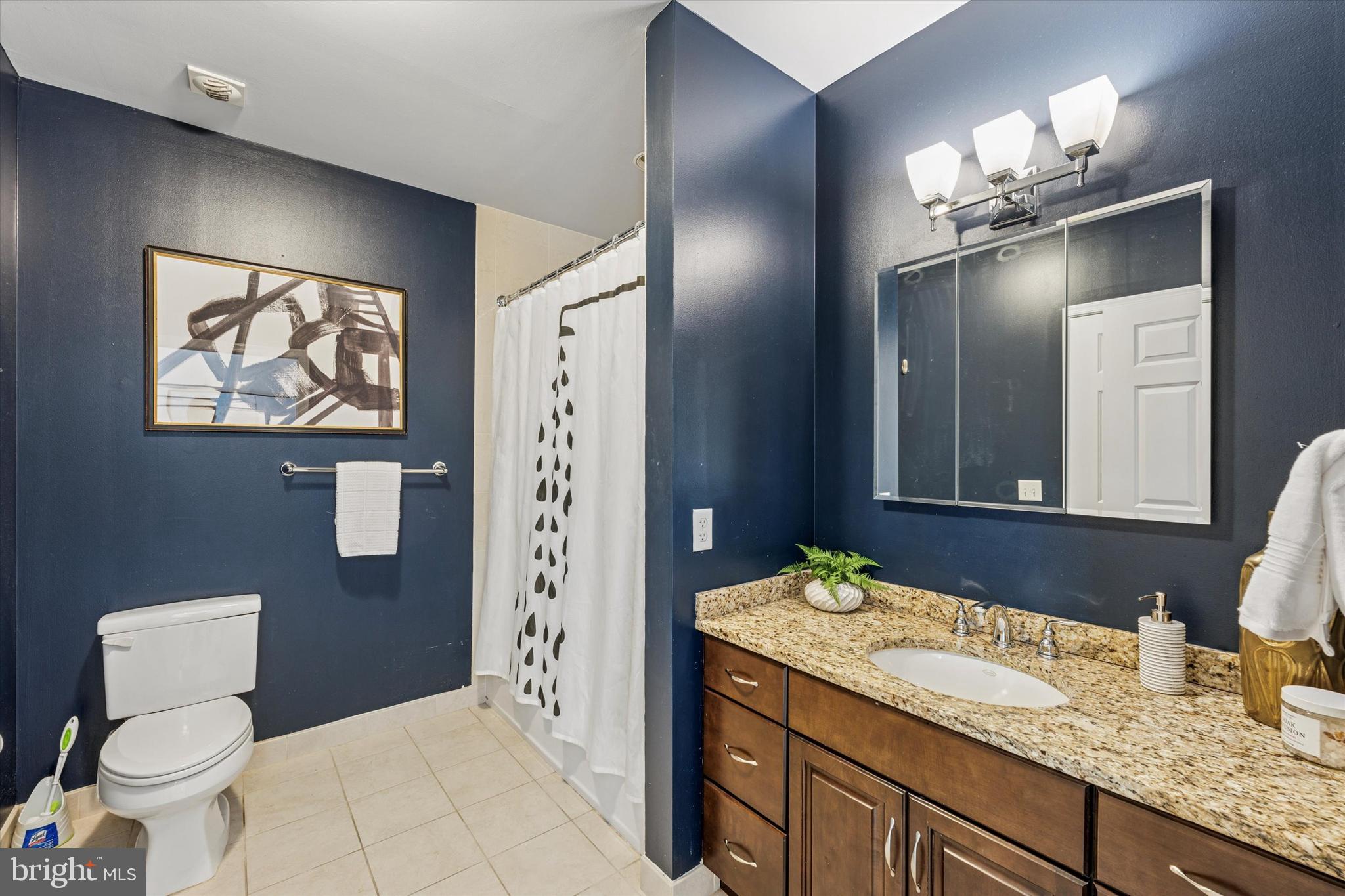 1600 Arch Street, Unit 1706 Philadelphia, PA 19103 - Photo 18 of 34 a bathroom with a granite countertop toilet a sink and a mirror