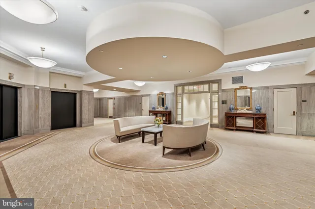 a living room with couches and a dining table with kitchen view