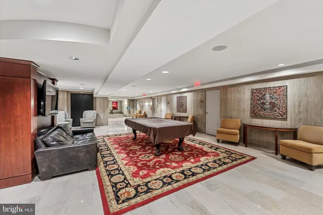 a living room with furniture a rug and a flat screen tv