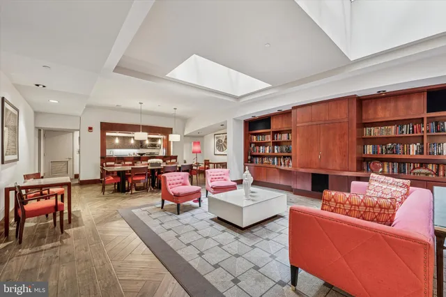 a living room with fireplace furniture and a book shelf