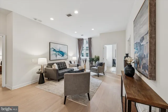 a living room with furniture or couch and a wooden floor