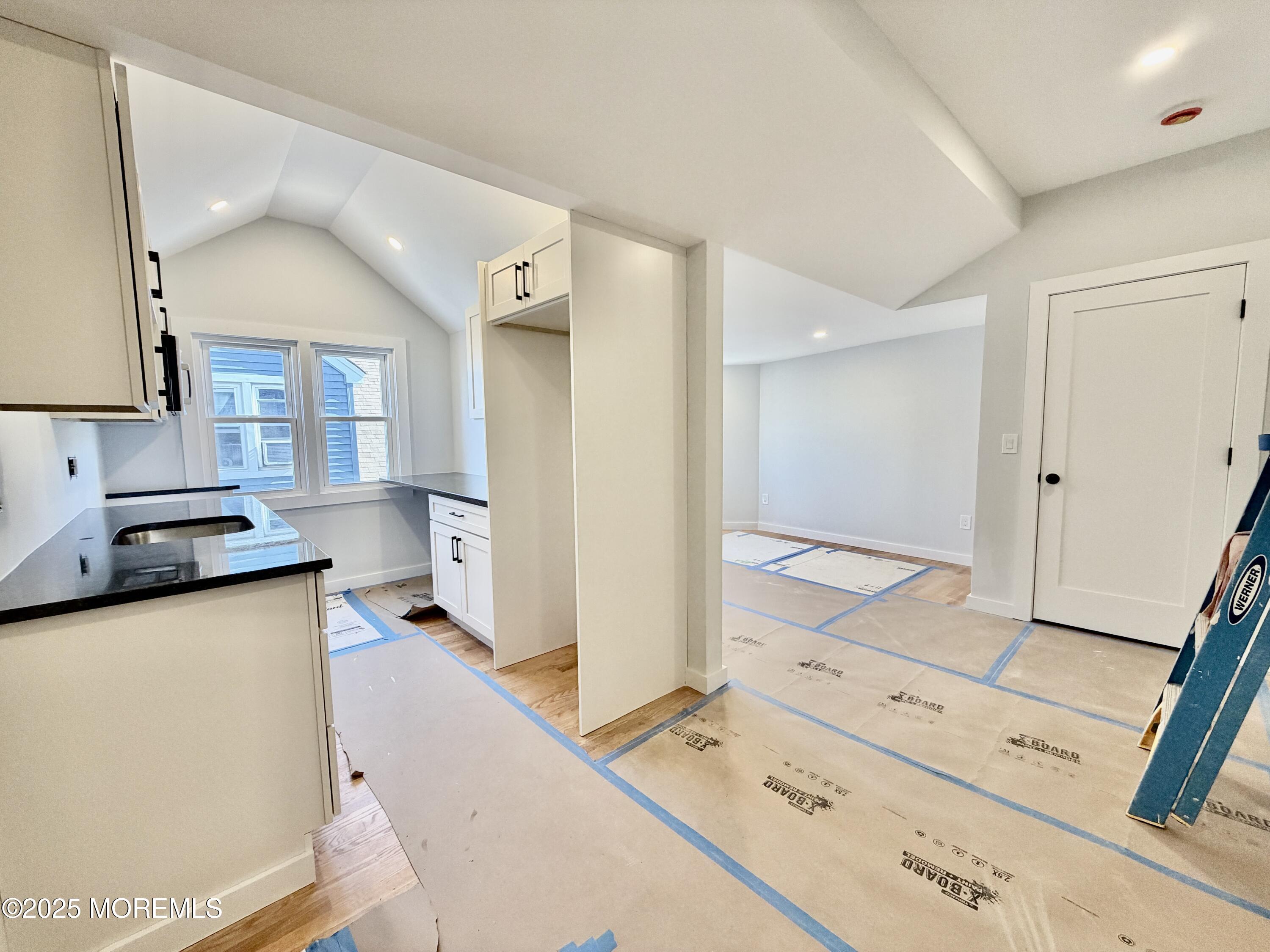 110 4th Avenue, Unit 9 Bradley Beach, NJ 07720 - Photo 6 of 9 a hall with stainless steel appliances granite countertop a sink and a stove top oven