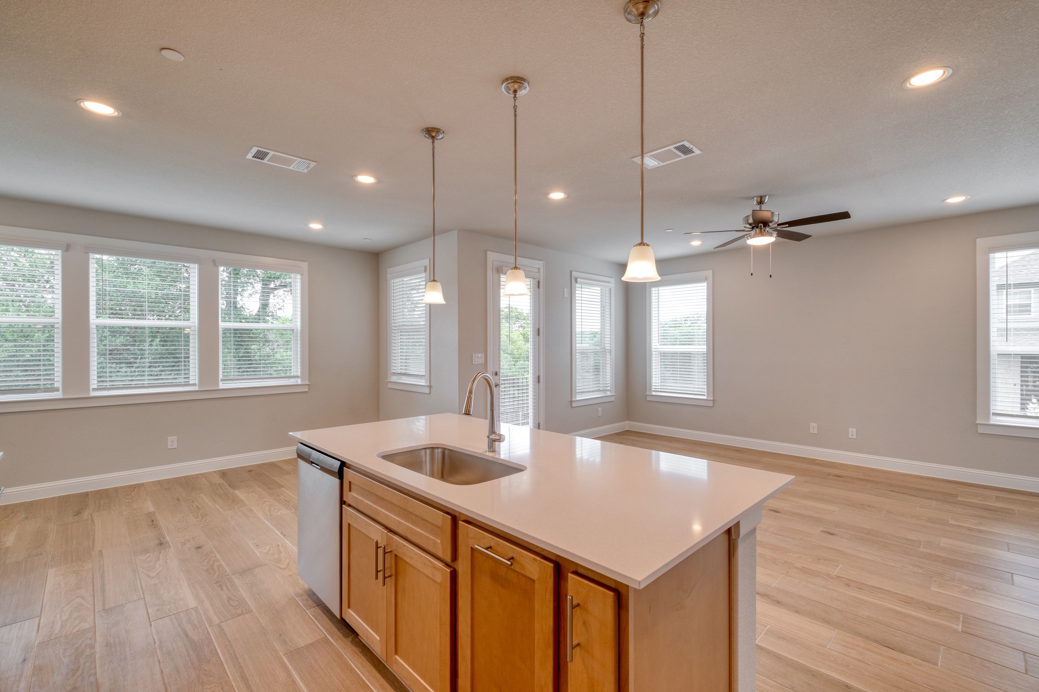 2605 Sam Bass Road, Unit 44 Round Rock, TX 78681 - Photo 12 of 26 View of the well-lit living area features a modern kitchen island, tile flooring, and ample natural light.