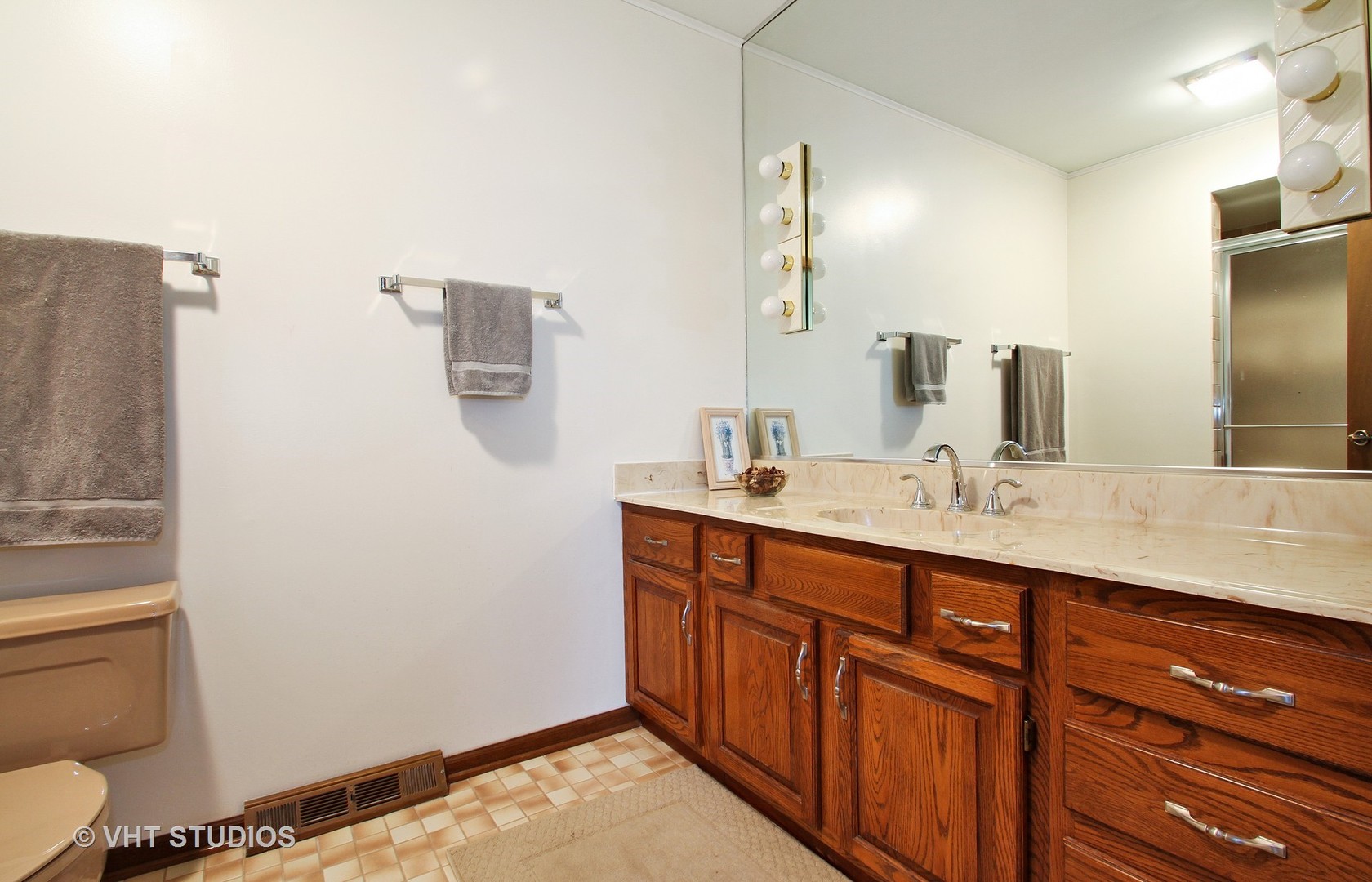 2740 Landwehr Road Northbrook, IL 60062 - Photo 11 of 15 a bathroom with a sink a toilet and a mirror