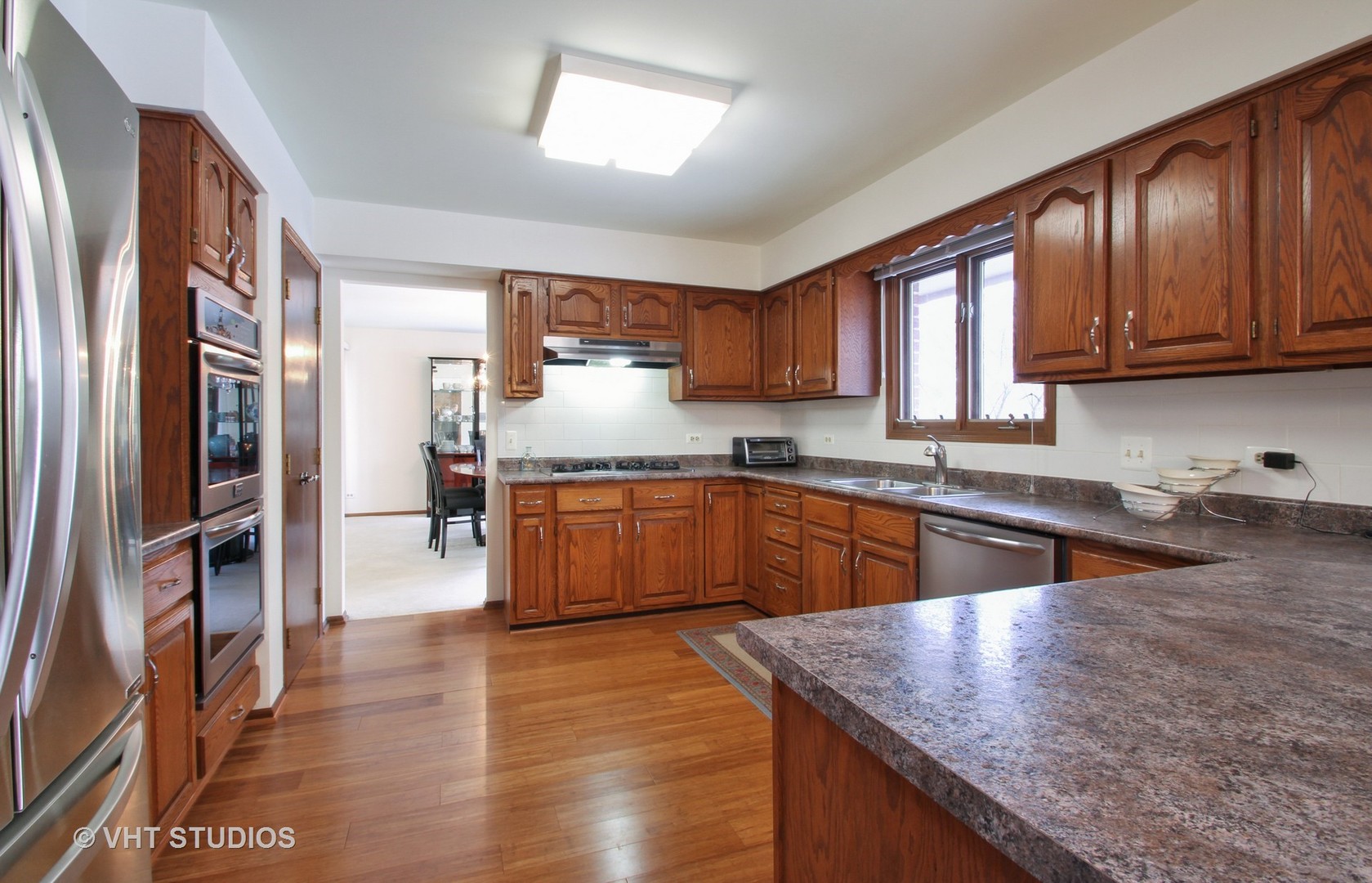2740 Landwehr Road Northbrook, IL 60062 - Photo 6 of 15 a kitchen with stainless steel appliances granite countertop a sink a stove and a refrigerator