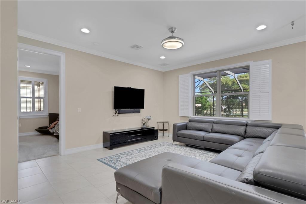 16309 Aberdeen Way Naples, FL 34110 - Photo 10 of 34 a living room with furniture and a flat screen tv