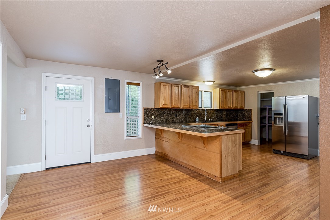 7586 Goodwin Road Everson, WA 98247 - Photo 14 of 22 a large kitchen with stainless steel appliances granite countertop a stove and a refrigerator