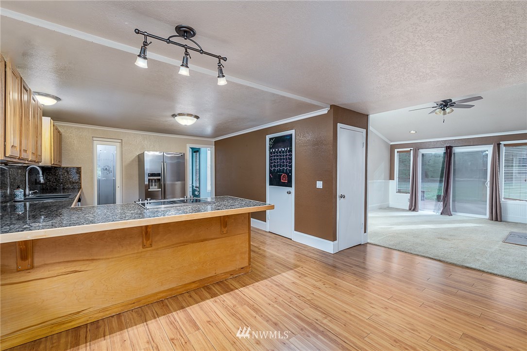 7586 Goodwin Road Everson, WA 98247 - Photo 8 of 22 a large white kitchen with wooden floor and a sink