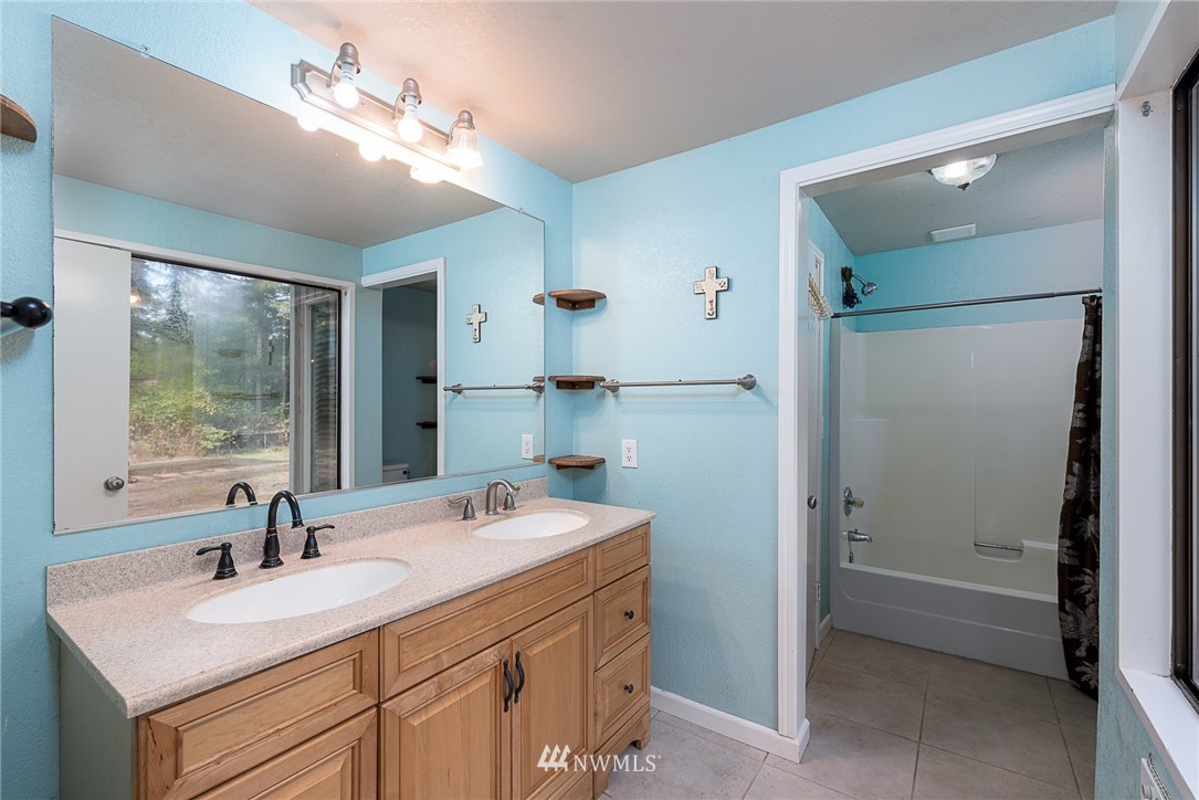 7586 Goodwin Road Everson, WA 98247 - Photo 10 of 22 a bathroom with a sink vanity granite and a mirror