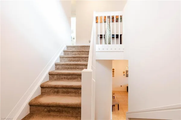 a view of staircase with white walls
