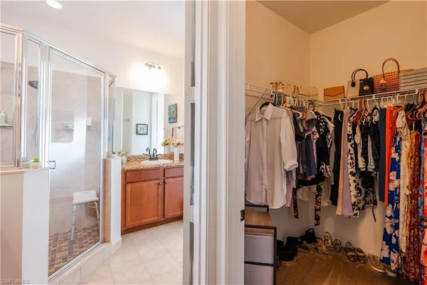 a view of walk in closet with clothes
