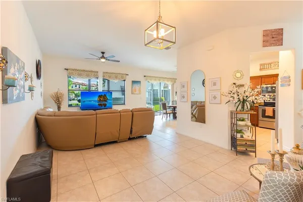 a living room with furniture and a chandelier